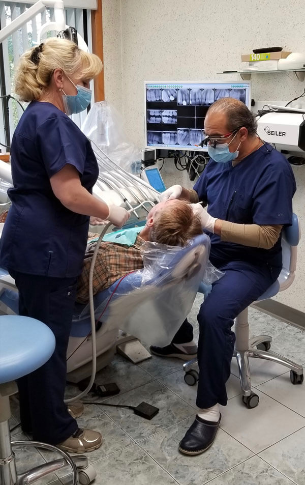 Dr. Roman Izmailov working with a patient in an exam room