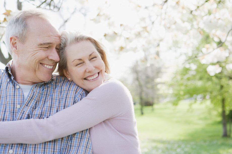 happy senior couple taking a walk in the park