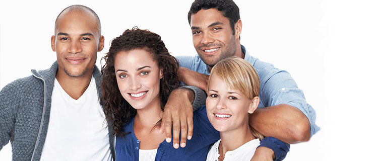 two men and two women, standing, leaning on each other, smiling